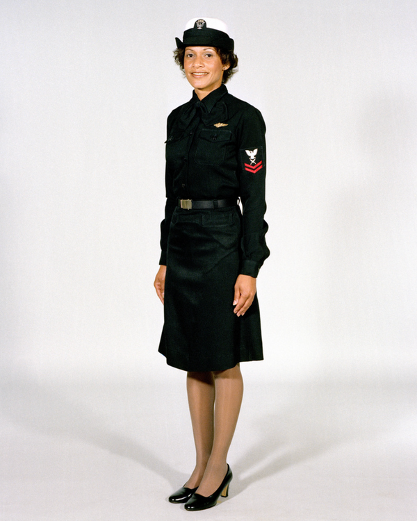 Navy Female Enlisted E6 & Below Winter Service Blue Uniform worn with skirt, necktab, combination cover and ribbons.