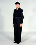Navy Female Enlisted E6 & Below Winter Working Blue Uniform worn with white combination cover.
