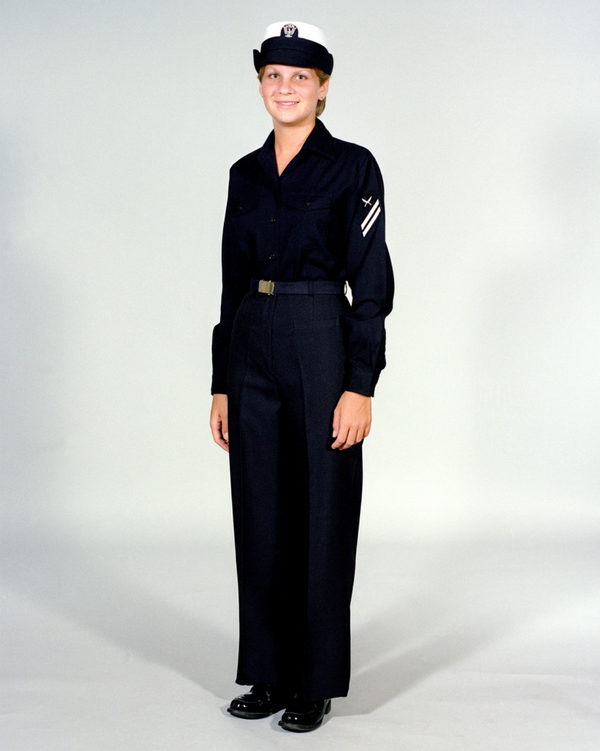 Navy Female Enlisted E6 & Below Winter Working Blue Uniform worn with white combination cover.