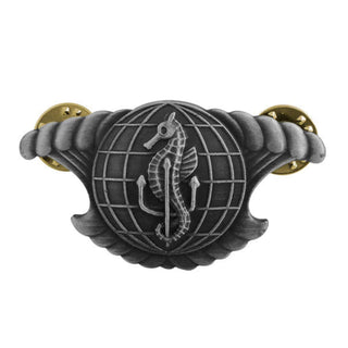 US NAVY Metal Badge Pin: Integrated Undersea Surveillance System Enlisted, Regulation Size in Silver Oxidized Finish.  The insignia features a seahorse & trident superimposed on a globe with a breaking wave in the background. It is a rare distinction, given exclusively to enlisted sailors with sonar ratings and limited duty/restricted line officers knowledgeable in sonar operations.  - Measures approx 2" wide x approx 1 1/8" high - Clutch back pin - Sold individually - Made in the USA.