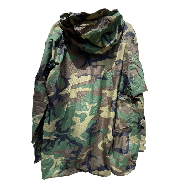 BDU Woodland Camo Wet Weather Parka. Men's USGI Military Improved Rainsuit Outerwear Jacket in green camouflage. This lightweight Rain Suit protects from wind, rain, and sea spray. Features adjustable roll-up visor hood, reinforced elbows, armpit zippers for ventilation, adjustable cuffs. Front 2-way zipper closure with snap storm flap, pass-through snap front pockets, drawstring hem, inner liner buttons. Genuine US Military Issue, 100% Nylon Shell, Made in U.S.A.
