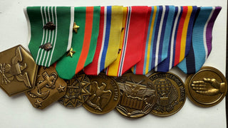 Genuine U.S. Military Armed Forces Medal Rack Set. Set includes Standard Regulation Full Size Medals (l-r): Army Commendation Medal with 2 bronze oak leaf cluster, Navy & Marine Corps Achievement Medal with 2 gold stars, Army Reserve Components Achievement Medal, National Defense Service Medal with 2 bronze stars, Global War on Terrorism Expeditionary Medal, Global War on Terrorism Service Medal, Humanitarian Service Medal. Mounted on a bar, Official U.S. Military Grade Medals, Made in the USA.