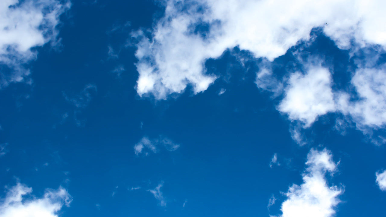 Blue sky with scattered white clouds