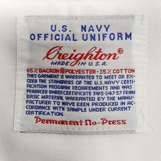 US NAVY Male White Long Sleeved Dress Shirt with NO Epaulets. Creighton brand label. U.S. NAVY OFFICIAL UNIFORM. White 65% Dacron Polyester, 35% Cotton. Made in U.S.A. Permanent No-Press