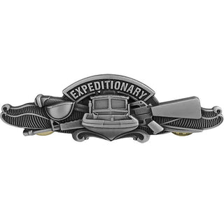 US NAVY Silver Oxide Metal Badge Expeditionary Warfare Specialist Enlisted, Regulation Full Size. Silver Oxidized Finish. Measures 3" wide x 1" high. Clutch back pin. Sold individually. Made in the USA. The design of the insignia encompasses the bow and superstructure of a Sea Ark patrol boat superimposed upon a crossed cutlass & M16A1 rifle.