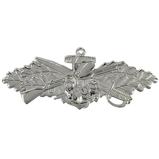 US NAVY Silver Metal Badge - Seabee Combat Warfare Specialist Enlisted, Regulation Full Size. Silver Mirror Finish. Measures approximately 2-3/4" wide x 1" high. Clutch back pin. Sold individually. Made in the USA.