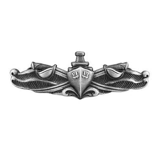 NAVY Metal Badge: Surface Warfare Enlisted - Oxidized Miniature. US NAVY Silver Metal Badge - Enlisted Surface Warfare Specialist (ESWS), Mini Size. Silver Oxide Finish. Measures 1 1/2"wide x 1/2"high. Clutch back pin. USN Certified. Made in the USA. Enlisted insignia features crossed cutlass swords with curved blades and handguards with a ship in the middle of the pin on waves.