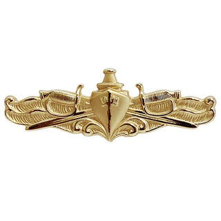 NAVY Metal Badge: Surface Warfare Officer - Gold Miniature. US NAVY Gold Metal Badge - Surface Warfare Officer (SWO), Mini Size. Gold Mirror Finish. Measures 1 1/2"wide x 1/2"high. Clutch back pin. USN Certified. Made in the USA. Officer insignia features waves breaking before the bow of a ship overlaid on crossed U.S. Navy commissioned officer's swords, rendered in gold.