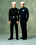 Navy Enlisted E6 & Below Winter Blue Uniform worn with white Dixie Cup cover, black tie and V-Neck Sweater