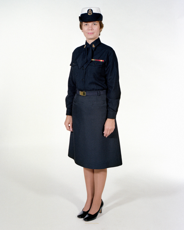 Navy Female CPO Winter Service Blue Uniform worn with skirt, necktab, ribbons, badges & white combination cover.