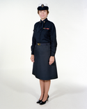 Navy Female CPO Winter Service Blue Uniform worn with skirt, necktab, ribbons, badges & white combination cover.