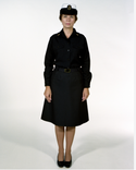 Navy Female CPO Winter Working Blue Uniform worn with skirt & white combination cover.