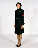 Navy Female Enlisted E6 & Below Winter Service Blue Uniform worn with skirt, necktab, combination cover and ribbons.