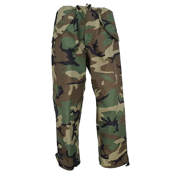 U.S. Military Battle Dress Uniform Gore Tex Pants in Woodland Camo. Cold weather woodland camouflage pants worn US Armed Services. Sealed seams for waterproof & windproof protection; weatherproof trousers feature elastic waist drawcord, snap fly closure, pass-through pockets, side cargo pockets, and hook & loop adjustable hems. The zippered leg seams for easy removal without taking off shoes. Genuine, US Military Navy Uniform. 100% Nylon Shell and Liner, PTFE Laminate Made in U.S.A.