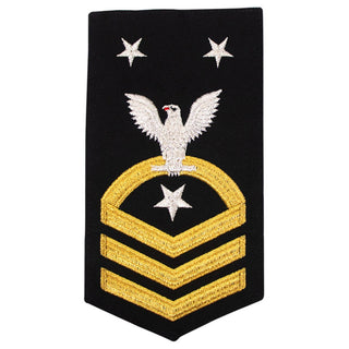 USN Male Rating Badge: E-9 Command Master Chief (CMC) - Standard Seaworthy Gold on Blue for Service Dress & Dinner Dress Blue uniform. Gold chevrons indicate 12 years of consecutive good conduct.  - CPO embroidered Regulation Gold Chevron on Blue with White Eagle and Designator.  - Gold & White Embroidery on Dark Blue Polyester Wool. - US Navy Certified - Made in the USA