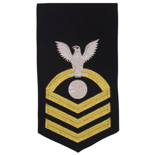 USN Male Rating Badge: E-7 Electricians Mate (EM) - Standard Seaworthy Gold on Blue for Service Dress & Dinner Dress Blue uniform. Gold chevrons indicate 12 years of consecutive good conduct.  - CPO embroidered Regulation Gold Chevron on Blue with White Eagle and Designator.  - Gold & White Embroidery on Dark Blue Polyester Wool. - US Navy Certified - Made in the USA