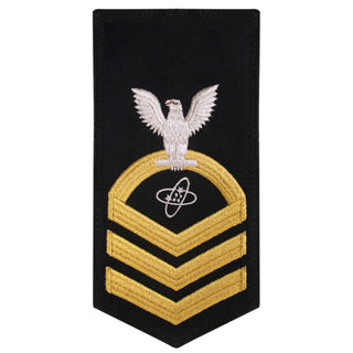 USN Male Rating Badge: E-7 Electronics Technician (ET) - Standard Seaworthy Gold on Blue for Service Dress & Dinner Dress Blue uniform. Gold chevrons indicate 12 years of consecutive good conduct.  - CPO embroidered Regulation Gold Chevron on Blue with White Eagle and Designator.  - Gold & White Embroidery on Dark Blue Polyester Wool. - US Navy Certified - Made in the USA