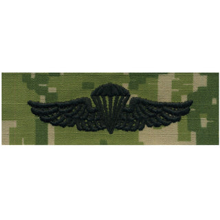 NAVY NWU Type III Badge: Parachutist. US NAVY Working Uniform Type 3 Embroidered Badge - Parachutist.  Official U.S. Navy tag to be used with NWU Type III Uniform.  - USN Certified - Black Embroidery on Green Woodland Digital Camouflage - Individually sold - Made in the USA