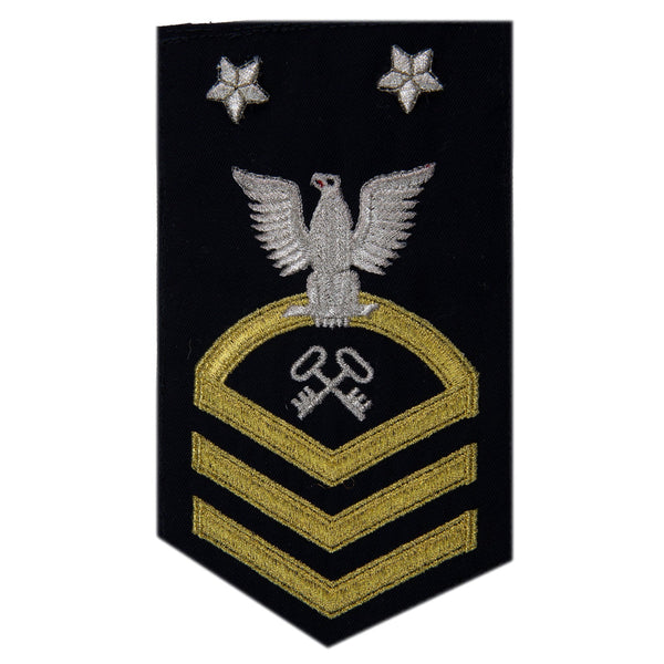 USN Male Rating Badge: E-9 Logistics Specialist (LS) - Seaworthy Gold on Blue for Dress Blue & Dinner Dress Blue uniform. MCPO embroidered Regulation Gold Chevron on Blue with White Eagle and Designator. Gold Chevrons Indicating Good Conduct Service.  - Fabric: Silver White & Gold Embroidery on Dark Blue Wool - Quality = Seaworthy/ Standard - US Navy Certified - Made in the USA - Condition: Good, pre-owned/gently used unless marked as NEW.
