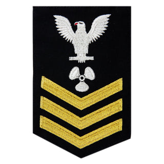 USN Male Rating Badge: E6 Machinists Mate (MM) - Standard Seaworthy Gold on Blue for Enlisted Service Dress & Dinner Dress Blue uniform. Gold chevrons indicate 12 years of consecutive good conduct.