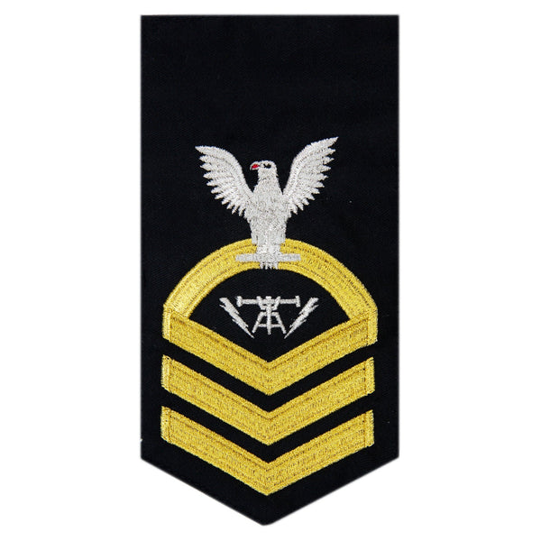 USN Male Rating Badge: E-7 Fire Controlman (FCC) - Standard Seaworthy Gold on Blue for Service Dress & Dinner Dress Blue uniform. Gold chevrons indicate 12 years of consecutive good conduct.  - CPO embroidered Regulation Gold Chevron on Blue with White Eagle and Designator.  - Gold & White Embroidery on Dark Blue Polyester Wool. - US Navy Certified - Made in the USA