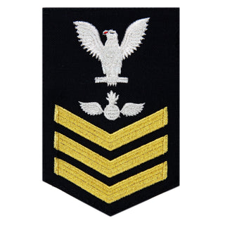 USN Male Rating Badge: E6 Aviation Ordinanceman (AO) - Standard Seaworthy Gold on Blue for Enlisted Service Dress & Dinner Dress Blue uniform. Gold chevrons indicate 12 years of consecutive good conduct.