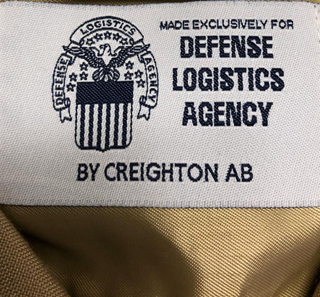 Label for U.S. Navy Men's NSU Khaki Shirt. Made exclusively for Defense Logistics Agency by Creighton AB.