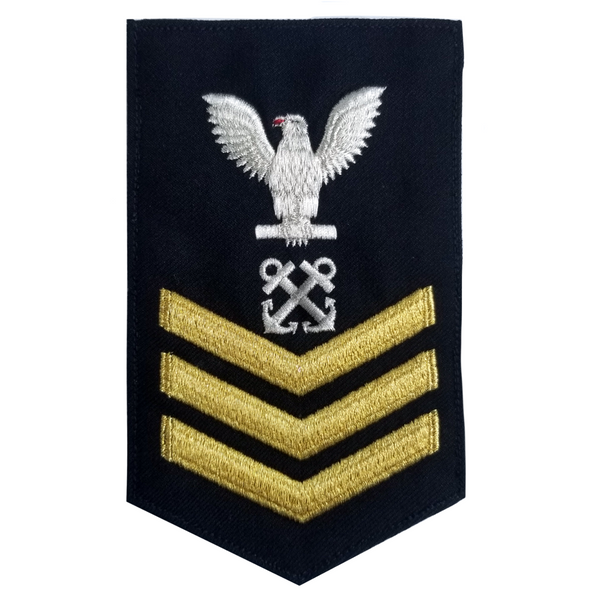 USN Male Rating Badge: E6 Boatswains Mate (BM) - Standard Seaworthy Gold on Blue for Enlisted Service Dress & Dinner Dress Blue uniform. Gold chevrons indicate 12 years of consecutive good conduct.