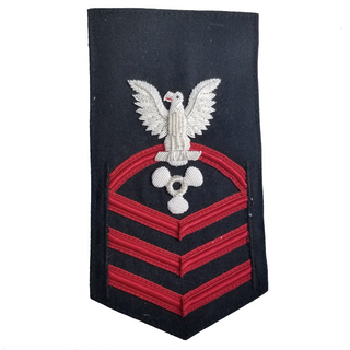USN Male Rating Badge: E7 CPO Chief Petty Officer - Machinists Mate (MM). Worn on Service Dress & Dinner Dress Blue uniform.  - Vanfine Bullion Silver Eagle & Designator with Red Lace on Dark Blue Gabardine Weave. - US Navy Certified - Made in the USA - Condition: Good, pre-owned/gently used.