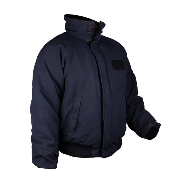 US NAVY Ship Board Cold Weather Jacket (FR) Flame Resistant. This Ship Board Coat features an optional stand-up collar, quilted liner, 2 zippered front inverted welt pockets, 2 interior patch pockets, front zipper closure with windflap, raglan sleeves with recessed knit cuff, and knitted waistband.  - Genuine, Official Military-Issued Navy Uniform - Color: Navy Blue - Fabric: Aramid (Fire Resistant) Outershell, Knit Cuffs & Waistband. Made in USA.