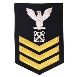 USN Female Rating Badge: E6 Boatswain’s Mate (BM) - Standard Seaworthy Gold on Blue for Enlisted Service Dress & Dinner Dress Blue uniform. Gold chevrons indicate 12 years of consecutive good conduct.